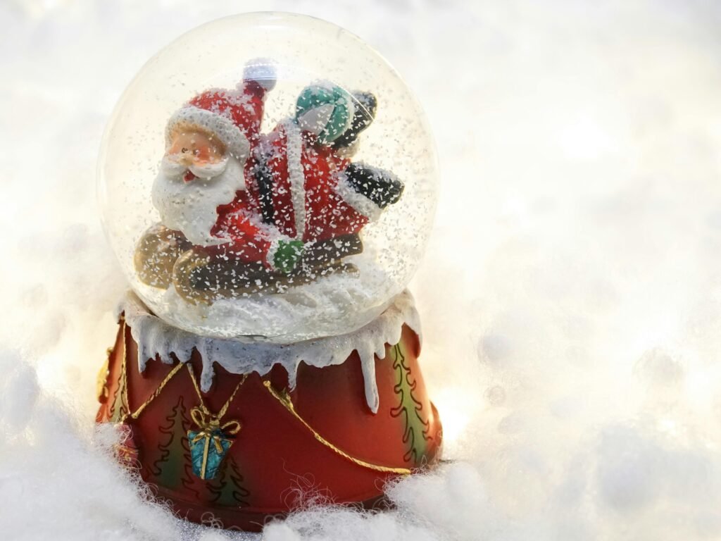 A charming snow globe featuring Santa Claus on a sled, perfect for Christmas decor.